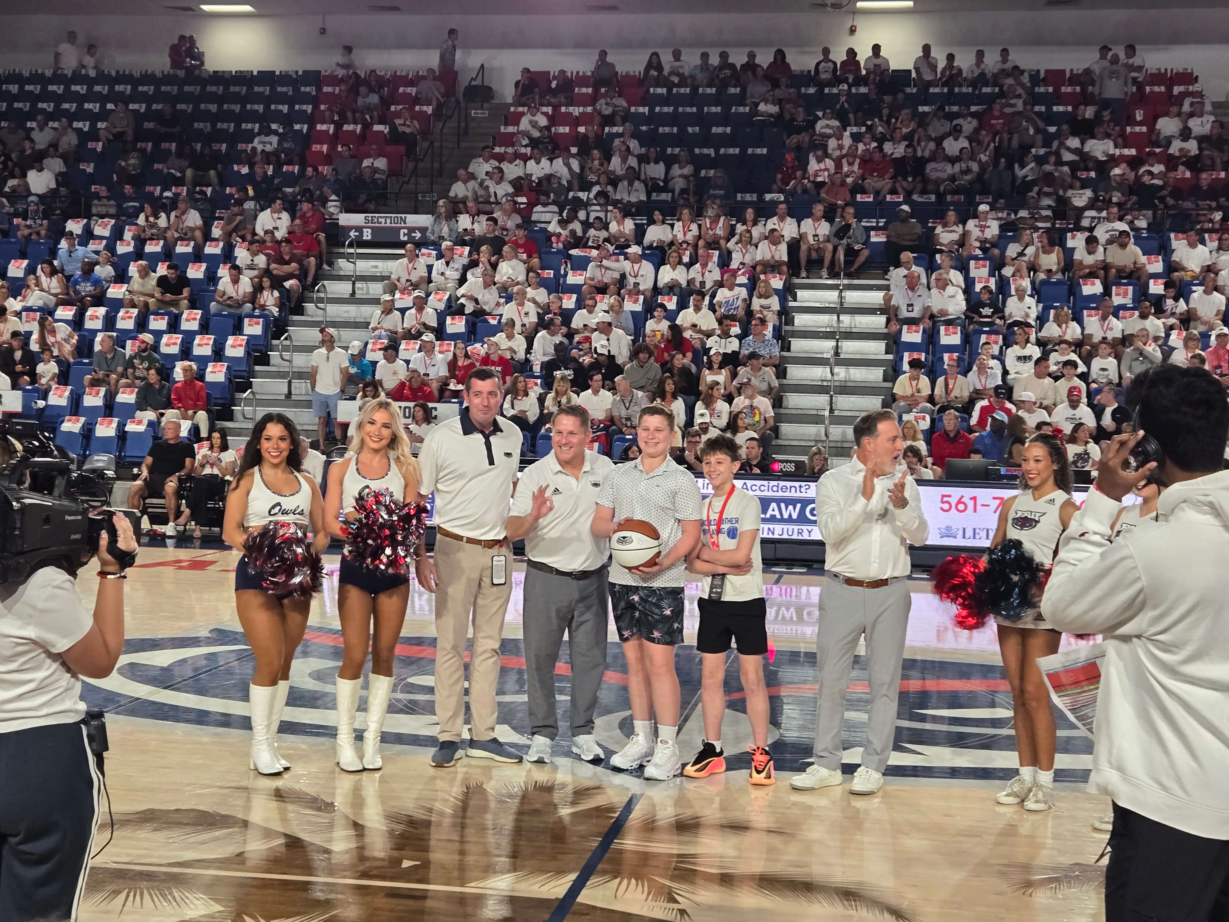 David Shiner at midcourt with the FAU athletic director